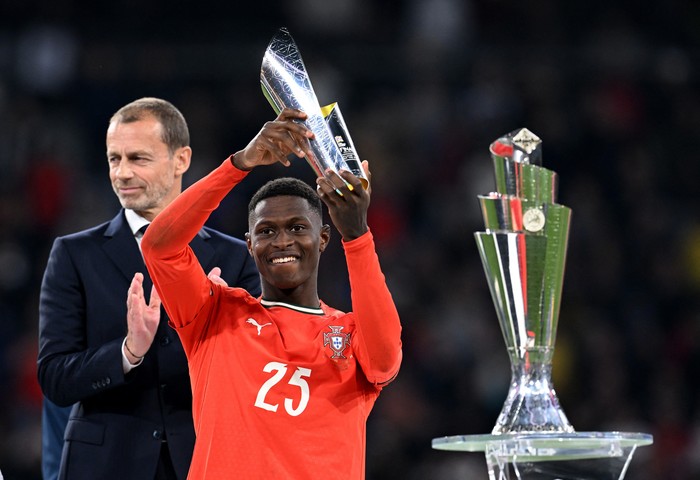 Nuno Mendes Soccer Football - Nations League - Final - Portugal v Spain - Allianz Arena, Munich, Germany - June 8, 2025 Portugals Nuno Mendes celebrates with a trophy after winning player of the tournament REUTERS/Angelika Warmuth