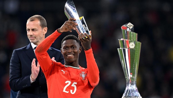 Nuno Mendes Soccer Football - Nations League - Final - Portugal v Spain - Allianz Arena, Munich, Germany - June 8, 2025 Portugals Nuno Mendes celebrates with a trophy after winning player of the tournament REUTERS/Angelika Warmuth