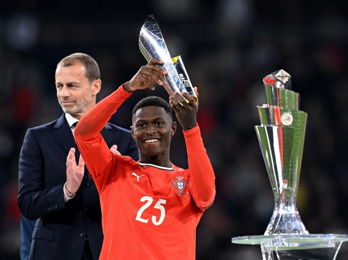 Soccer Football - Nations League - Final - Portugal v Spain - Allianz Arena, Munich, Germany - June 8, 2025 Portugal's Nuno Mendes celebrates with a trophy after winning player of the tournament REUTERS/Angelika Warmuth