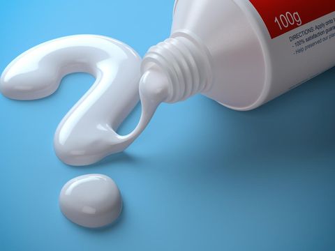 Toothpaste in the shape of question mark coming out from toothpaste tube. Brushing teeth dental concept. 3d illustration