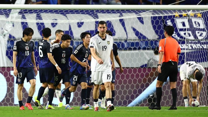 Soccer Football - World Cup - AFC Qualifiers - Group C - Japan v Indonesia - Suita City Stadium, Suita, Japan - June 10, 2025 Indonesias Thom Jan Haye looks dejected as Japans Mao Hosoya celebrates scoring their sixth goal with teammates REUTERS/Issei Kato