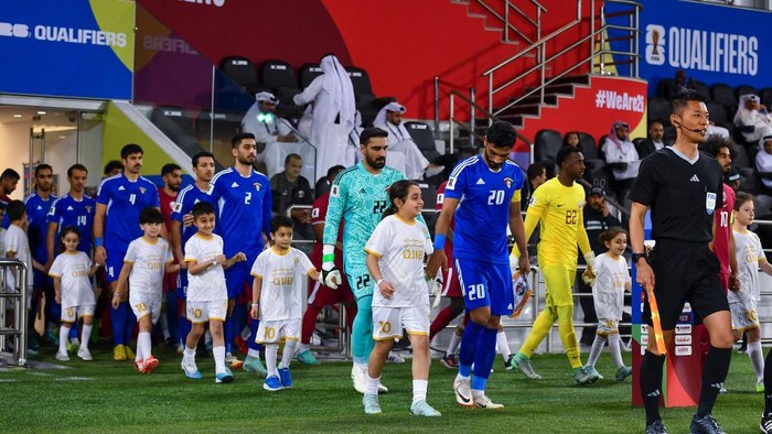 Players from Kuwait and Qatar are walking onto the field before the start of the Qualification Round for the FIFA World Cup 2026 and AFC Asian Cup 2027 Group A match between Qatar and Kuwait at Jassim Bin Hamad Stadium in Doha, Qatar, on March 21, 2024. (Photo by Noushad Thekkayil/NurPhoto via Getty Images)