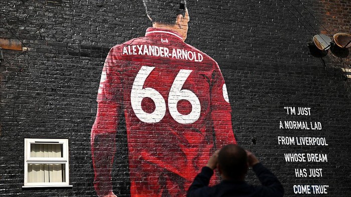 LIVERPOOL, ENGLAND - APRIL 13: Fans of Liverpool take a picture of a mural which features Trent Alexander-Arnold of Liverpool on the side of a house prior to the Premier League match between Liverpool FC and West Ham United FC at Anfield on April 13, 2025 in Liverpool, England. (Photo by Justin Setterfield/Getty Images)