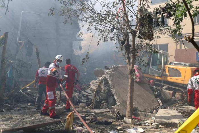 Rescuers work at the site of a damaged building, in the aftermath of Israeli strikes, in Tehran, Iran, June 13, 2025. Iranian Red Crescent Society/WANA (West Asia News Agency)/Handout via REUTERS Purchase Licensing Rights