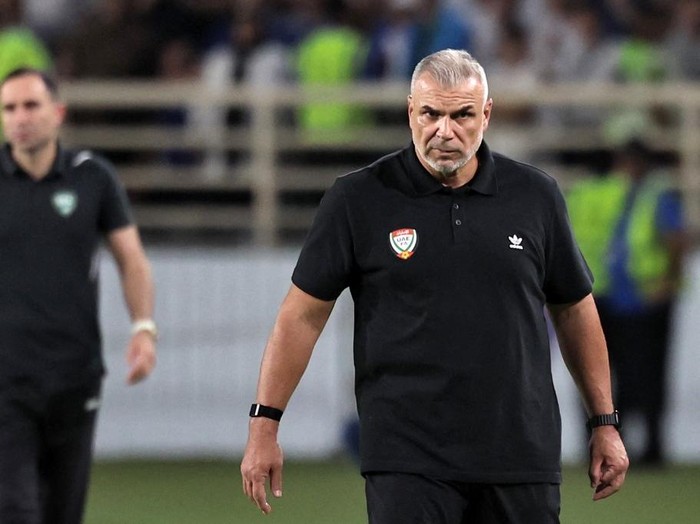 UAE's Romanian coach Cosmin Olaroiu (R) reacts during the 2026 FIFA World Cup Asian Qualifier football match between the United Arab Emirates and Uzbekistan at Al-Nahyan Stadiumin Abu Dhabi on June 5, 2025. (Photo by Fadel SENNA / AFP)