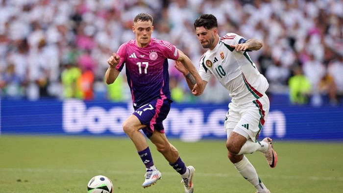 STUTTGART, GERMANY - JUNE 19: Dominik Szoboszlai of Hungary vies with Florian Wirtz of Germany  during the UEFA EURO 2024 group stage match between Germany and Hungary at Stuttgart Arena on June 19, 2024 in Stuttgart, Germany. (Photo by Stefan Matzke - sampics/Getty Images)