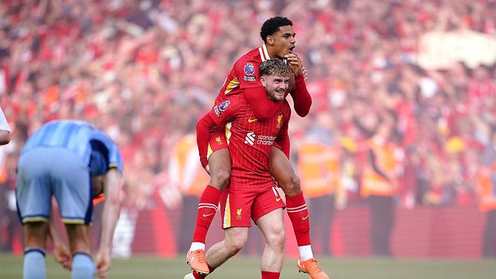Liverpools Harvey Elliott (bottom) and Jarell Quansah celebrate victory and the Premier League title following the Premier League match at Anfield, Liverpool. Picture date: Sunday April 27, 2025. (Photo by Peter Byrne/PA Images via Getty Images)