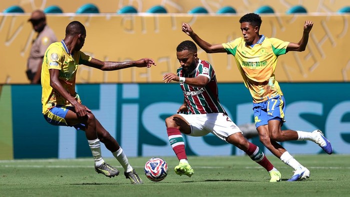 MIAMI GARDENS, FLORIDA - JUNE 25: Samuel Xavier #2 of Fluminense FC runs with the ball while under pressure from Divine Lunga #29 and Tashreeq Matthews #17 of Mamelodi Sundowns FC during the FIFA Club World Cup 2025 group F match between Mamelodi Sundowns FC and Fluminense FC at Hard Rock Stadium on June 25, 2025 in Miami Gardens, Florida. (Photo by Megan Briggs/Getty Images)