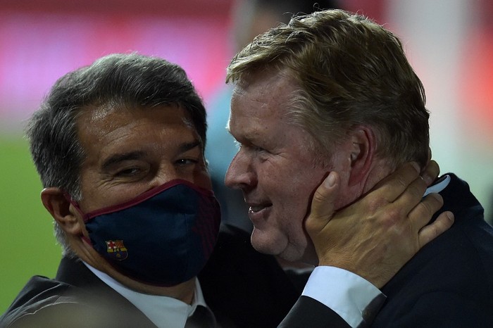 Barcelonas Dutch coach Ronald Koeman (R) celebrates with club president Joan Laporta at the end of the Spanish Copa del Rey (Kings Cup) final football match between Athletic Club Bilbao and FC Barcelona at La Cartuja stadium in Seville on April 17, 2021. (Photo by CRISTINA QUICLER / AFP)