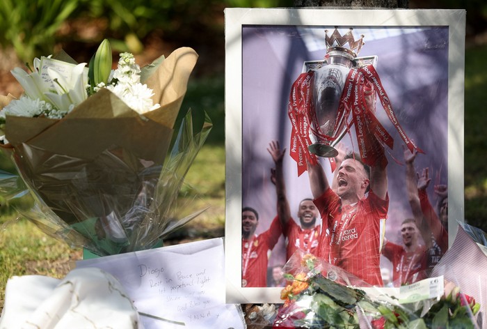 A picture of Liverpools Portuguese soccer player Diogo Jota stands next to flower tributes, after Jota died in a car crash near Zamora, Spain, outside Anfield Stadium in Liverpool, Britain, July 3, 2025. REUTERS/Temilade Adelaja