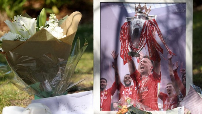 A picture of Liverpools Portuguese soccer player Diogo Jota stands next to flower tributes, after Jota died in a car crash near Zamora, Spain, outside Anfield Stadium in Liverpool, Britain, July 3, 2025. REUTERS/Temilade Adelaja