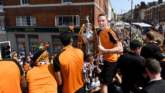 WOLVERHAMPTON, ENGLAND - MAY 07: Diogo Jota of Wolverhampton Wanderers with the trophy during their celebrations of winning the Sky Bet Championship on a winners parade around the city of Wolverhampton on May 7, 2018 in Wolverhampton, England. (Photo by Sam Bagnall - AMA/Getty Images)