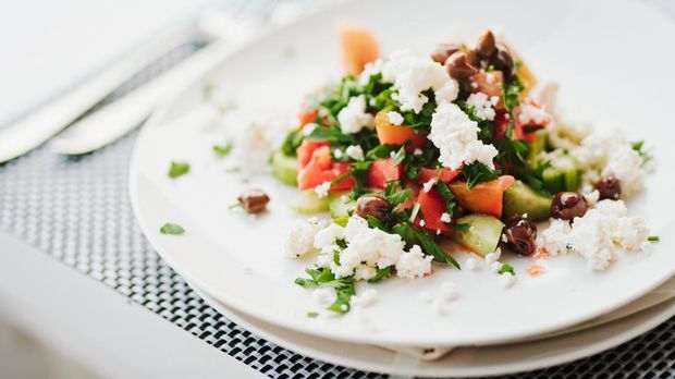 Shopska salad (Bulgaria) Tomato salad with white cheese in a restaurant. Shopska salad
