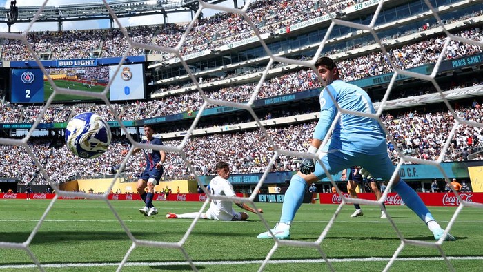 thibaut courtois real madrid paris saint-germain vs real madrid psg vs madrid psg vs real madrid piala dunia antarklub 2025 EAST RUTHERFORD, NEW JERSEY - JULY 09: (EDITORS NOTE: Image was captured using a remote camera from behind the goal.) Fabian Ruiz #8 of Paris Saint-Germain scores his teams third goal past Federico Valverde and Thibaut Courtois #1 of Real Madrid C.F. during the FIFA Club World Cup 2025 semi-final match between Paris Saint-Germain and Real Madrid CF at MetLife Stadium on July 09, 2025 in East Rutherford, New Jersey. (Photo by Dan Mullan/Getty Images)
