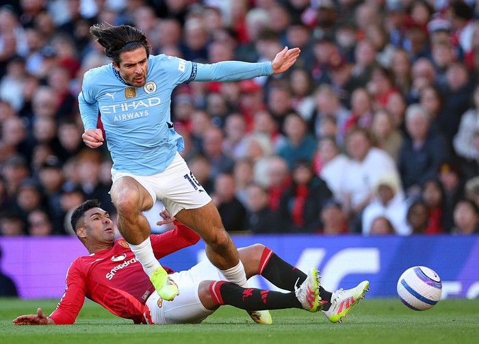 MANCHESTER, ENGLAND - APRIL 6: Casemiro of Manchester United and Jack Grealish of Manchester City challenge during the Premier League match between Manchester United FC and Manchester City FC at Old Trafford on April 6, 2025 in Manchester, England. (Photo by Ed Sykes/Sportsphoto/Allstar via Getty Images)
