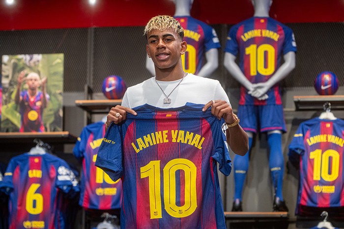 Lamine Yamal BARCELONA CATALONIA, SPAIN - JULY 16: Footballer Lamine Yamal poses with a jersey after signing his contract with FC Barcelona on July 16, 2025, in Barcelona, Catalonia, Spain. The striker renews his contract with FC Barcelona until 2031, making him one of the club's highest-paid players. The agreement, which came into effect on July 13 when he turned 18, ensures his continuity with the team until that date. The base salary will be 15 million euros per year, with the possibility of increasing to 20 million euros if he meets performance and title objectives. (Photo By Lorena Sopena/Europa Press via Getty Images)
