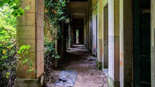 A ruined Hospital lies crumbling on the abandoned and supposedly haunted Poveglia Island in Italy.