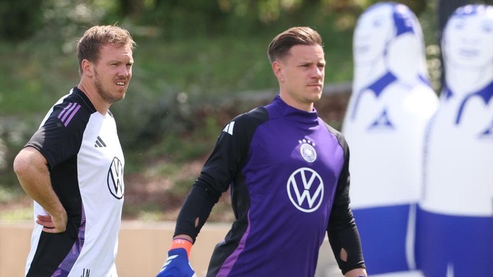 HERZOGENAURACH, GERMANY - JUNE 06: Julian Nagelsmann, Head Coach of Germany looks on with his keeper Marc-Andre ter Stegen during a training session on day six of the training camp at Herzo Base on June 06, 2024 in Herzogenaurach, Germany. The German team prepares for the European Football Championships EURO 2024 in Herzogenaurach.  (Photo by Alexander Hassenstein/Getty Images)