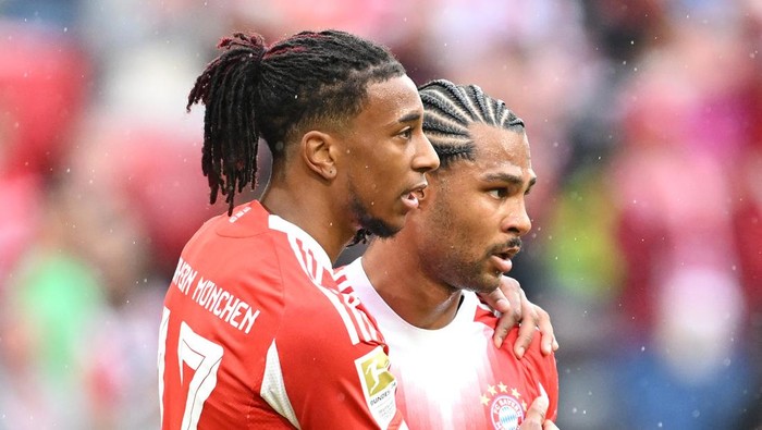 MUNICH, GERMANY - AUGUST 02: Michael Olise of Bayern Munich celebrates scoring his teams second goal with teammate Serge Gnabry during the pre-season friendly match between FC Bayern München and Olympique Lyonnais at Allianz Arena on August 02, 2025 in Munich, Germany. (Photo by Christian Kaspar-Bartke/Getty Images)