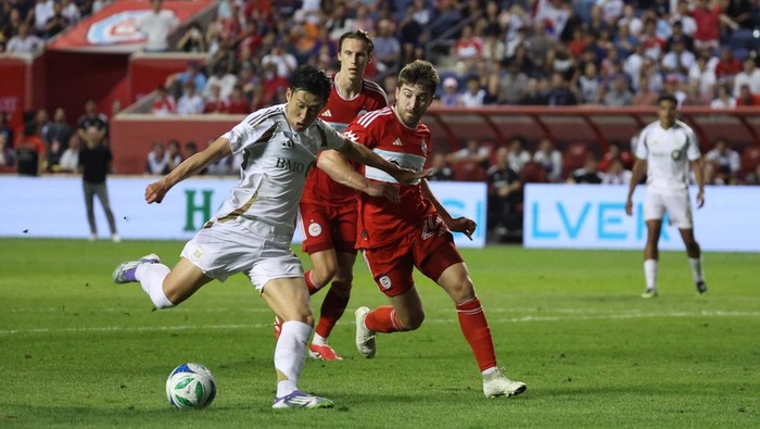 Aug 9, 2025; Bridgeview, Illinois, USA: Los Angeles FC forward Son Heung-Min (7) and Chicago Fire defender Jonathan Dean (24) battle for control of the ball during the second half at SeatGeek Stadium. Mandatory Credit: Talia Sprague-Imagn Images