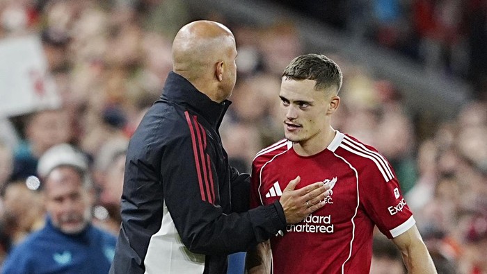 Liverpool manager Arne Slot (left) and Florian Wirtz (right) embrace as he is substituted during the pre-season friendly match at Anfield, Liverpool. Picture date: Monday August 4, 2025. (Photo by Peter Byrne/PA Images via Getty Images)