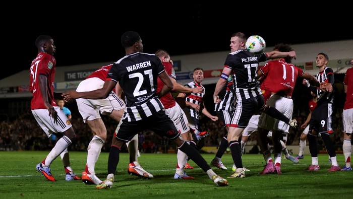 GRIMSBY, ENGLAND - AUGUST 27: Harry Maguire of Manchester United (hidden) scores his teams second goal during the Carabao Cup Second Round match between Grimsby Town and Manchester United at Blundell Park on August 27, 2025 in Grimsby, England.  (Photo by George Wood/Getty Images)