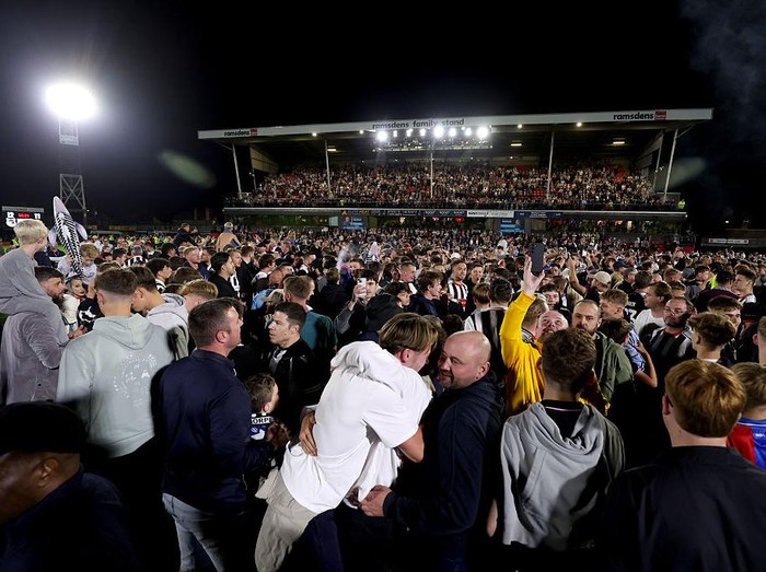 Grimsby Town's fans celebrate their victory after their penalty shoot out victory against Manchester United during the Carabao Cup second round match at Hill Blundell Park, Grimsby. Picture date: Wednesday August 27, 2025. (Photo by Nigel French/PA Images via Getty Images)