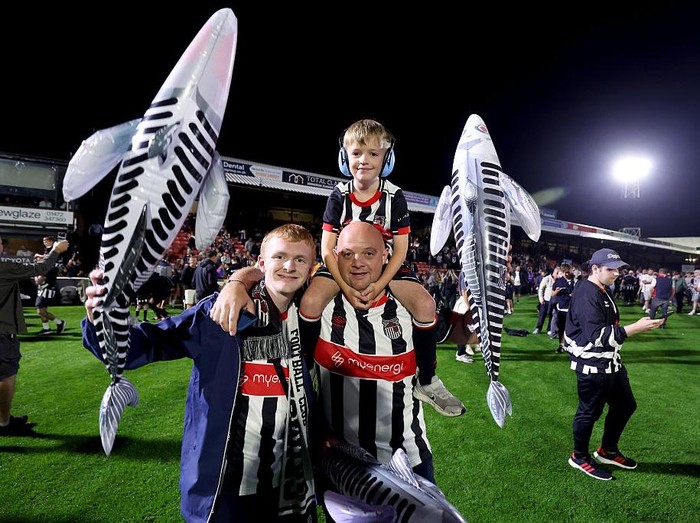 Grimsby Town's fans celebrate their victory after their penalty shoot out victory against Manchester United during the Carabao Cup second round match at Hill Blundell Park, Grimsby. Picture date: Wednesday August 27, 2025. (Photo by Nigel French/PA Images via Getty Images)