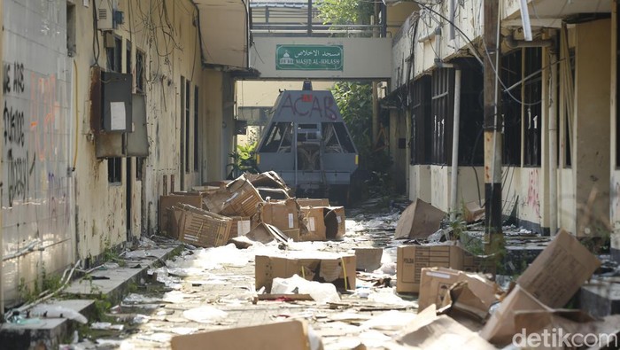 Markas Gegana di Jalan Kramat Raya hancur diamuk massa. Dua bus hangus masih terparkir di depan, sementara warga berkerumun menyaksikan kondisi bangunan, Sabtu (30/8/2025).