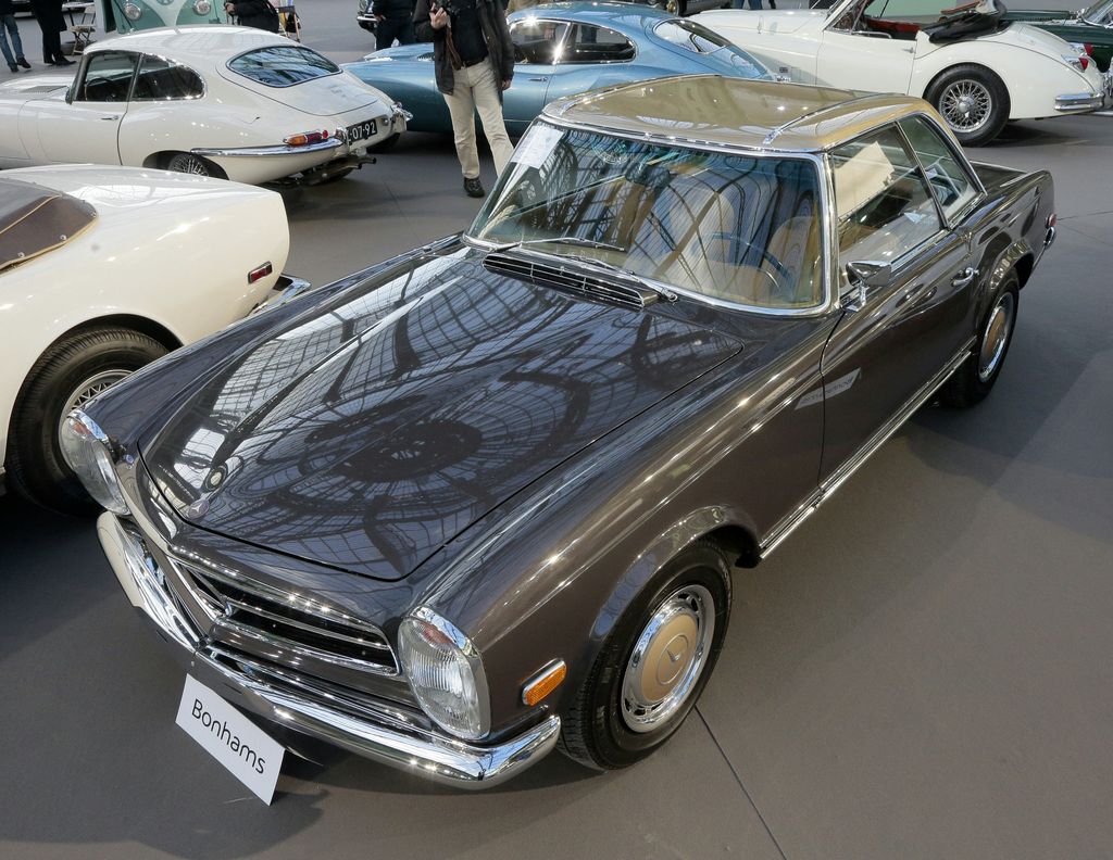 A photo taken on February 3, 2016 shows a 1969 Mercedes Benz 280 SL cabriolet with hardtop auctioned in favour of the charitable association of the A.P.H.P (Assistance Publique  Hopitaux de Paris -the public hospital system) on display during a sale of vintage cars and motorcycles at the Grand Palais in Paris. (Photo by JACQUES DEMARTHON / AFP)