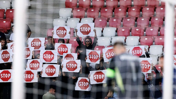 DEBRECEN, HUNGARY - SEPTEMBER 8: Supporters hold up Stop sign in protest against Israel during the FIFA World Cup 2026 qualifier match between Israel and Italy at Nagyerdei Stadion on September 8, 2025 in Debrecen, Hungary. (Photo by Maciej Rogowski/Eurasia Sport Images/Getty Images)