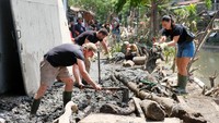 Potret WNA Ikut Gotong Royong Bersihkan Lumpur Pascabanjir di Bali