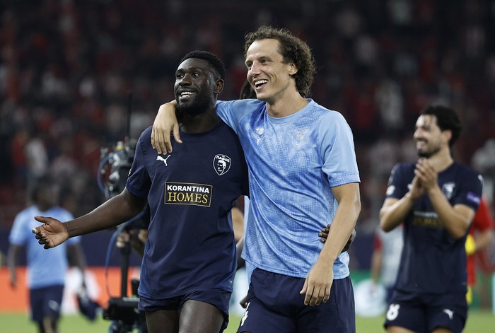 Soccer Football - UEFA Champions League - Olympiacos v Pafos - Karaiskakis Stadium, Piraeus, Greece - September 17, 2025 Pafos Derrick Luckassen and David Luiz react at the end of the match REUTERS/Louisa Gouliamaki
