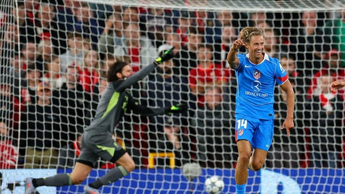 Soccer Football - UEFA Champions League - Liverpool v Atletico Madrid - Anfield, Liverpool, Britain - September 17, 2025 Atletico Madrids Marcos Llorente celebrates scoring their first goal as Liverpools Alisson Becker reacts Action Images via Reuters/Andrew Boyers