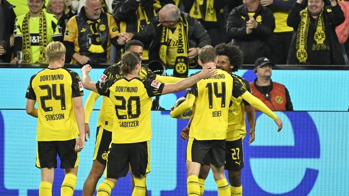 Dortmunds German forward #27 Karim Adeyemi (R) celebrates with teammates scoring his teams first goal during the German first division Bundesliga football match between Borussia Dortmund and VfL Wolfsburg in Dortmund on September 21, 2025. (Photo by INA FASSBENDER / AFP) / DFL REGULATIONS PROHIBIT ANY USE OF PHOTOGRAPHS AS IMAGE SEQUENCES AND/OR QUASI-VIDEO