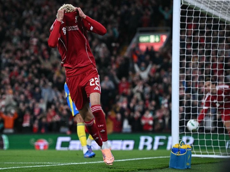 Liverpool's French striker #22 Hugo Ekitike starts to remove his shirt as he celebrates scoring their second goal, he was then sent off after picking up his second yellow card, during the English League Cup third round football match between Liverpool and Southampton at Anfield in Liverpool, north west England on September 23, 2025. (Photo by Paul ELLIS / AFP) / RESTRICTED TO EDITORIAL USE. No use with unauthorized audio, video, data, fixture lists, club/league logos or 'live' services. Online in-match use limited to 120 images. An additional 40 images may be used in extra time. No video emulation. Social media in-match use limited to 120 images. An additional 40 images may be used in extra time. No use in betting publications, games or single club/league/player publications. /
