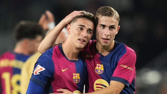BARCELONA, SPAIN - OCTOBER 20: Gavi and Fermin Lopez of FC Barcelona embrace at full-time following the teams victory in the La Liga EA Sports match between FC Barcelona and Sevilla FC at Estadi Olimpic Lluis Companys on October 20, 2024 in Barcelona, Spain. (Photo by Alex Caparros/Getty Images)
