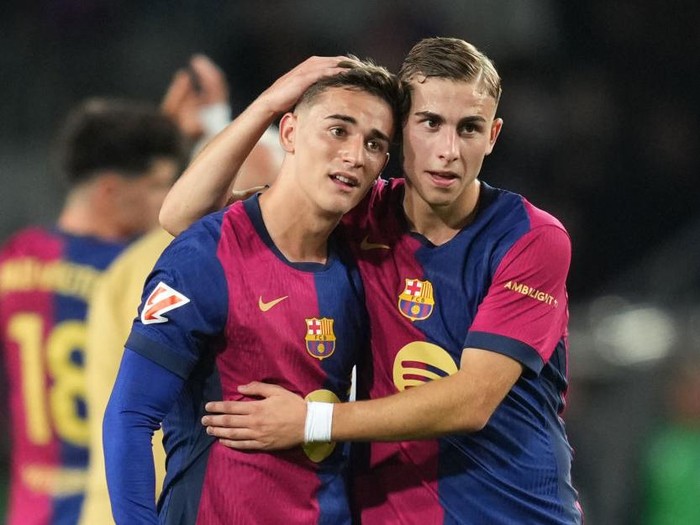 BARCELONA, SPAIN - OCTOBER 20: Gavi and Fermin Lopez of FC Barcelona embrace at full-time following the team's victory in the La Liga EA Sports match between FC Barcelona and Sevilla FC at Estadi Olimpic Lluis Companys on October 20, 2024 in Barcelona, Spain. (Photo by Alex Caparros/Getty Images)