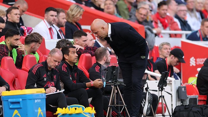 LIVERPOOL, ENGLAND - AUGUST 31: Arne Slot, Manager of Liverpool, speaks with assistant coach Giovanni van Bronckhorst during the Premier League match between Liverpool and Arsenal at Anfield on August 31, 2025 in Liverpool, England. (Photo by Carl Recine/Getty Images)