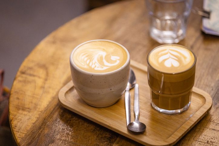Two mugs of coffee are on the table.