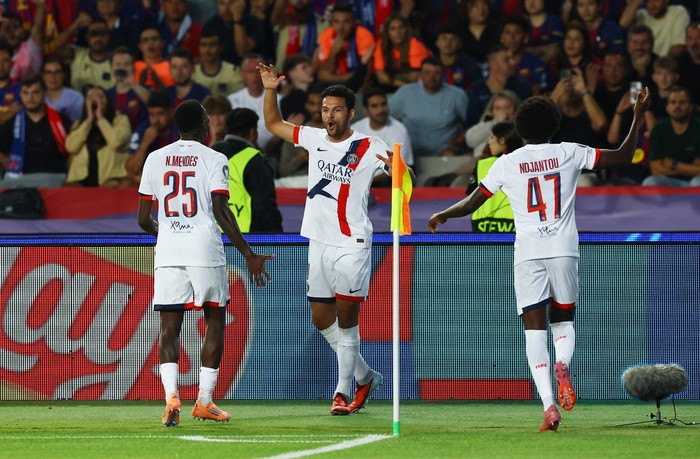 Soccer Football - UEFA Champions League - FC Barcelona v Paris St Germain - Estadi Olimpic Lluis Companys, Barcelona, Spain - October 1, 2025 Paris St Germains Goncalo Ramos celebrates scoring their second goal with Nuno Mendes and Quentin Ndjantou REUTERS/Albert Gea