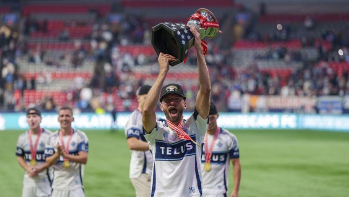 Oct 1, 2025; Vancouver, British Columbia, CAN;  Vancouver Whitecaps FC midfielder Thomas Muller (13) celebrates with the Voyagers Cup after a victory over Vancouver FC at BC Place. Mandatory Credit: Christopher Morris-Imagn Images