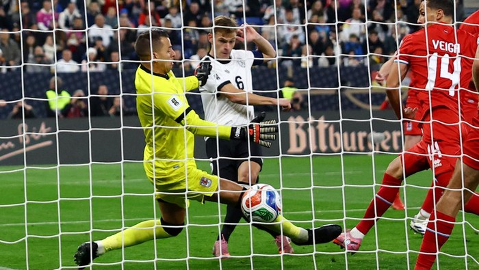 Soccer Football - FIFA World Cup - UEFA Qualifiers - Group A - Germany v Luxembourg - Rhein-Neckar-Arena, Sinsheim, Germany - October 10, 2025 Germanys Joshua Kimmich scores their fourth goal past Luxembourgs Anthony Moris REUTERS/Kai Pfaffenbach