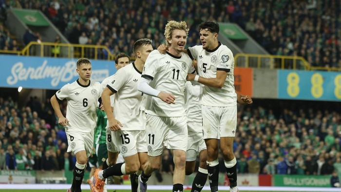 Soccer Football - FIFA World Cup - UEFA Qualifiers - Group A - Northern Ireland v Germany - Windsor Park, Belfast, Northern Ireland - October 13, 2025 Germanys Nick Woltemade celebrates scoring their first goal with Aleksandar Pavlovic REUTERS/Clodagh Kilcoyne