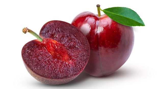 red cherry plum with green leaf isolated on white background