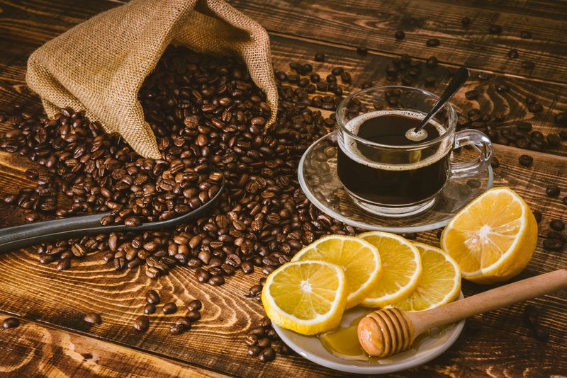 Coffee cup and beans on old kitchen table. Top view with copy space for your text. coffee bag and with sliced 