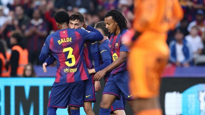 Barcelonas Spanish midfielder #08 Pedri celebrates scoring his teams first goal with teammates during the Spanish league football match between FC Barcelona and Girona FC at Estadi Olimpic Lluis Companys in Barcelona on October 18, 2025. (Photo by Josep LAGO / AFP)
