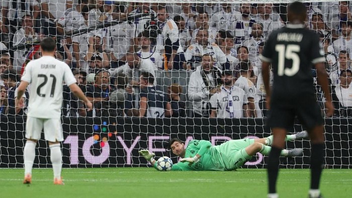 Real Madrids Belgian goalkeeper #01 Thibaut Courtois saves the ball during the UEFA Champions League league phase day 3 football match between Real Madrid CF and Juventus at Santiago Bernabeu Stadium in Madrid on October 22, 2025. (Photo by Pierre-Philippe MARCOU / AFP)
