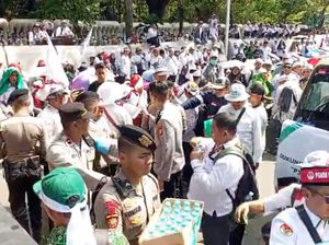 Polisi Bagi-bagi Air Mineral dan Roti ke Guru Pendemo di Monas Polisi Bagi-bagi Air Mineral dan Roti ke Guru Pendemo di Monas