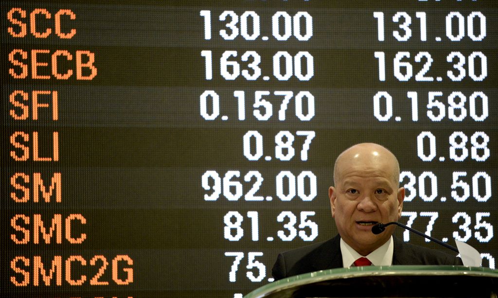 San Miguel Corporation President Ramon Ang speaks in front of a giant electronic board at the Philippine Stock Exchange during the listing of San Miguel in Manila's financial district on March 30, 2016. (Photo by NOEL CELIS / AFP)